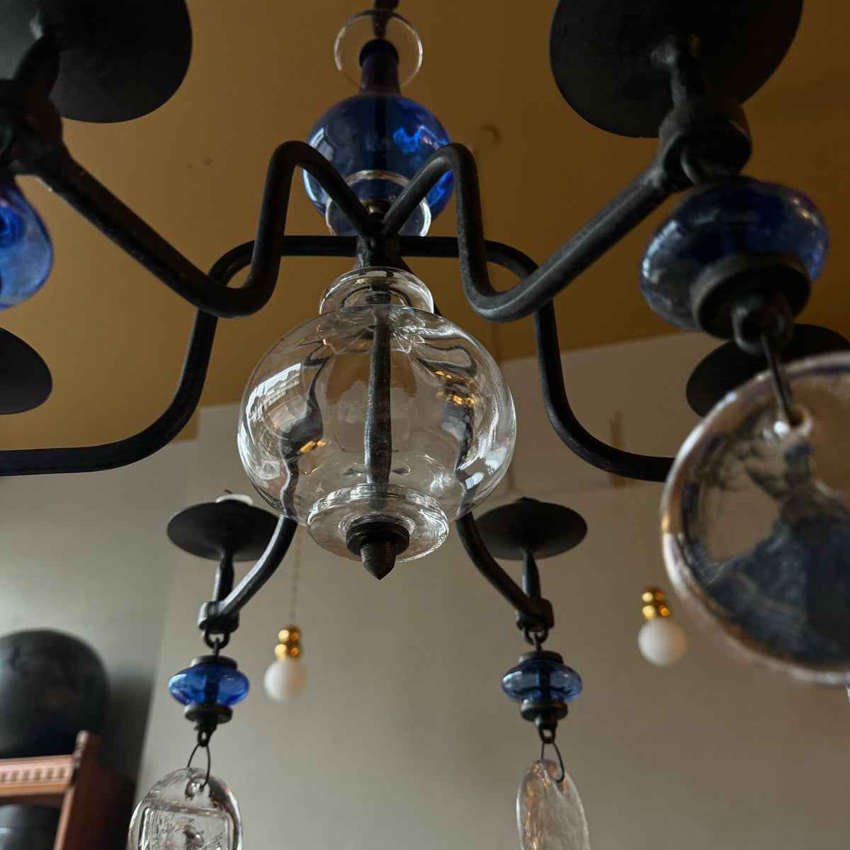 A 1960s blue chandelier by Erik Höglund, featuring pressed glass fish details and an iron frame. Crafted for Boda in Sweden, this vintage piece is available from Sigmar and exemplifies mid-century Scandinavian design.