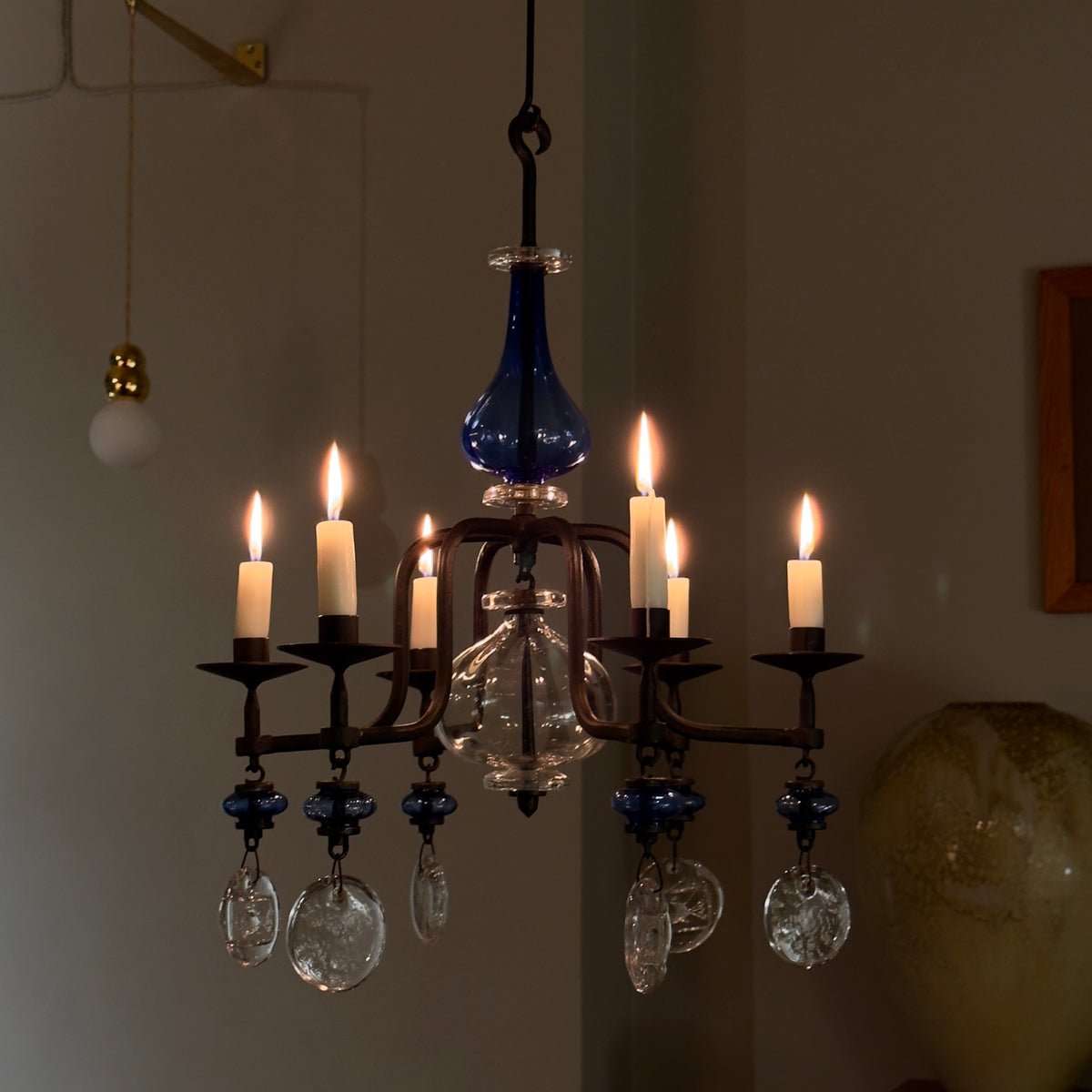 A 1960s blue chandelier by Erik Höglund, featuring pressed glass fish details and an iron frame. Crafted for Boda in Sweden, this vintage piece is available from Sigmar and exemplifies mid-century Scandinavian design.