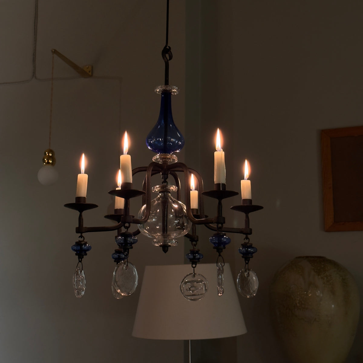 A 1960s blue chandelier by Erik Höglund, featuring pressed glass fish details and an iron frame. Crafted for Boda in Sweden, this vintage piece is available from Sigmar and exemplifies mid-century Scandinavian design.