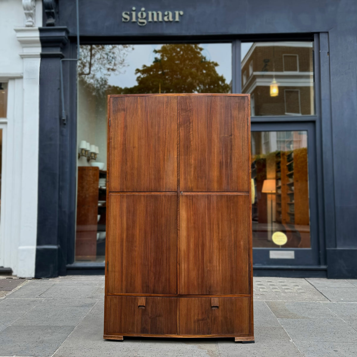 A large mahogany wardrobe designed in Denmark, retailed by Illums Bolighus, and attributed to Kaare Klint. This 1940s piece draws inspiration from Georgian design, showcasing exceptional Danish craftsmanship and timeless elegance.