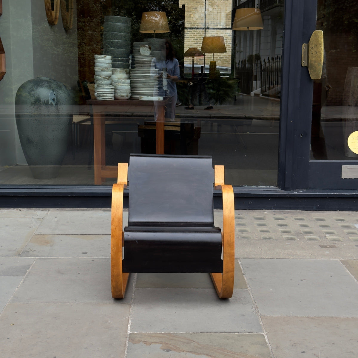 An Alvar Aalto-designed Finmar 31 armchair, featuring black curved plywood. This armchair is an iconic example of Finnish modernism, showcased by Sigmar Design Gallery in London.