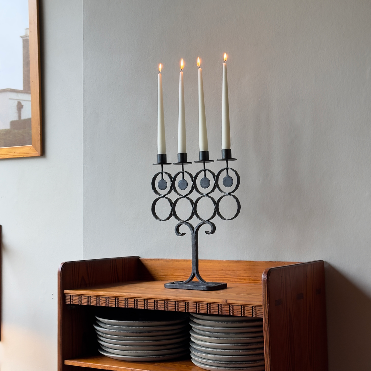 A vintage 1960s iron candelabrum by Bertil Vallien, made in Sweden for Boda Smide. This mid-century piece reflects Vallien's organic design style and the influence of Swedish folk art.