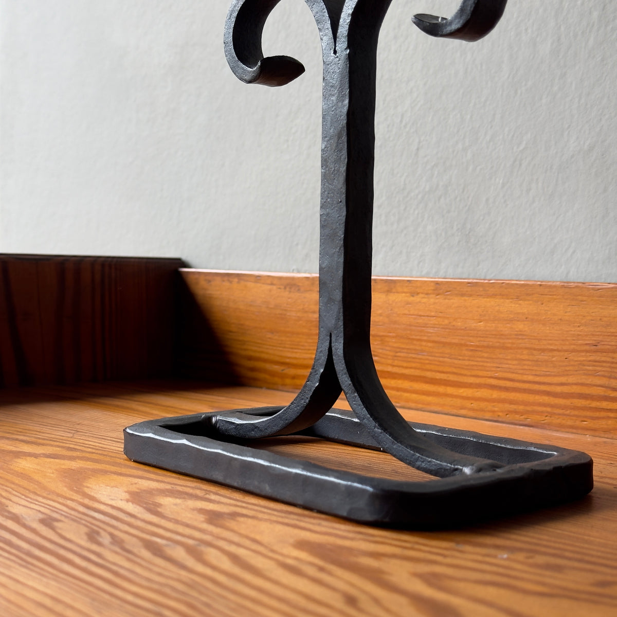 A vintage 1960s iron candelabrum by Bertil Vallien, made in Sweden for Boda Smide. This mid-century piece reflects Vallien's organic design style and the influence of Swedish folk art.