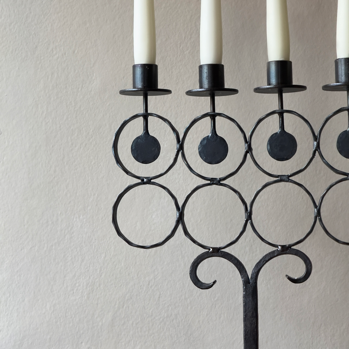 A vintage 1960s iron candelabrum by Bertil Vallien, made in Sweden for Boda Smide. This mid-century piece reflects Vallien's organic design style and the influence of Swedish folk art.