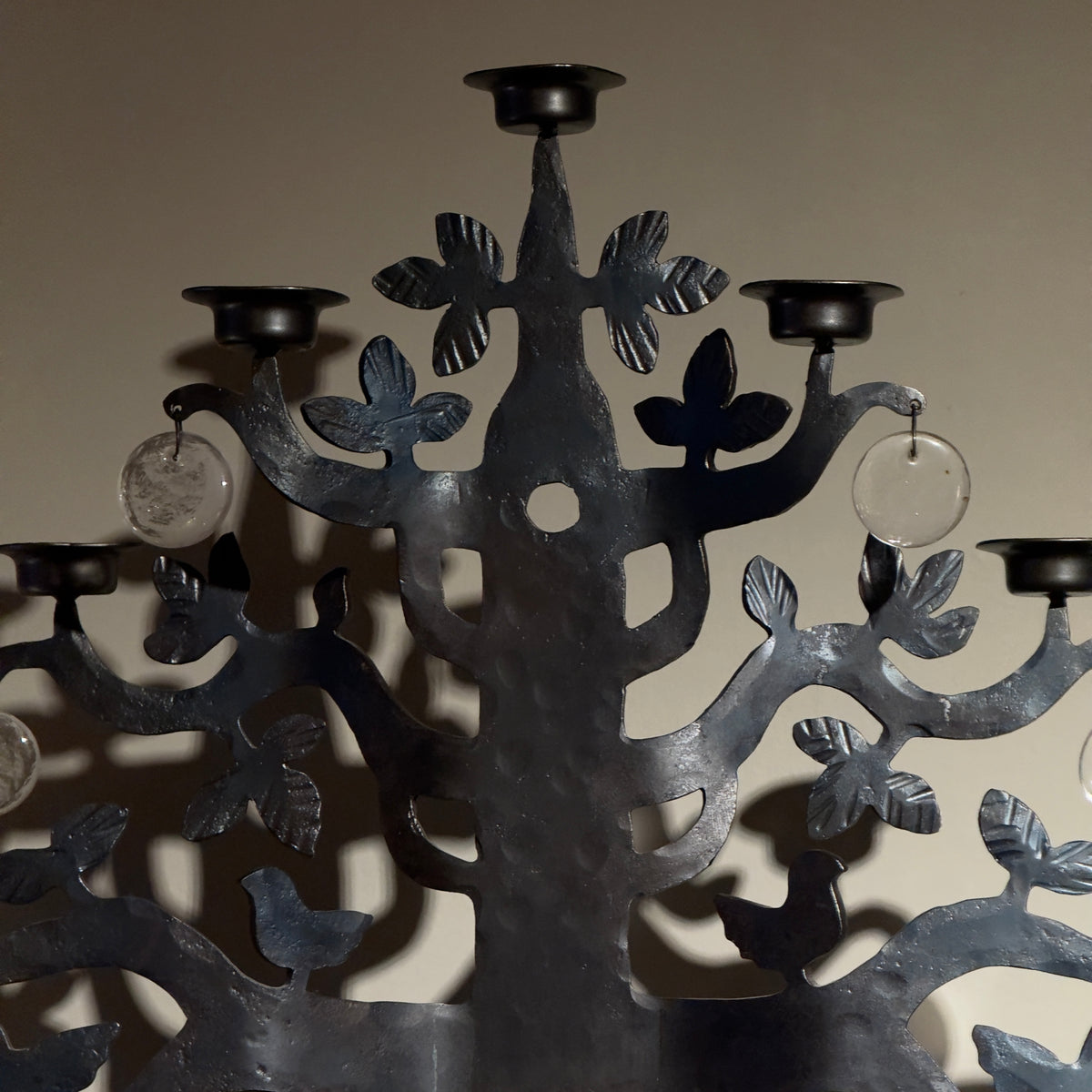 A 1970s 'Tree of Life' wrought iron standing candelabrum chandelier by Bertil Vallien for Boda Smide, Sweden. This vintage piece combines iron and glass elements, showcasing Vallien's artistic vision and Swedish craftsmanship, available from Sigmar.