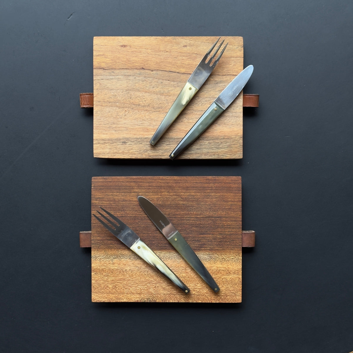 A pair of walnut picnic boards designed by Carl Aubock II during the 1950s. The combination of materials and neat construction are characteristic of the work produced by the prestigious Austrian workshop.