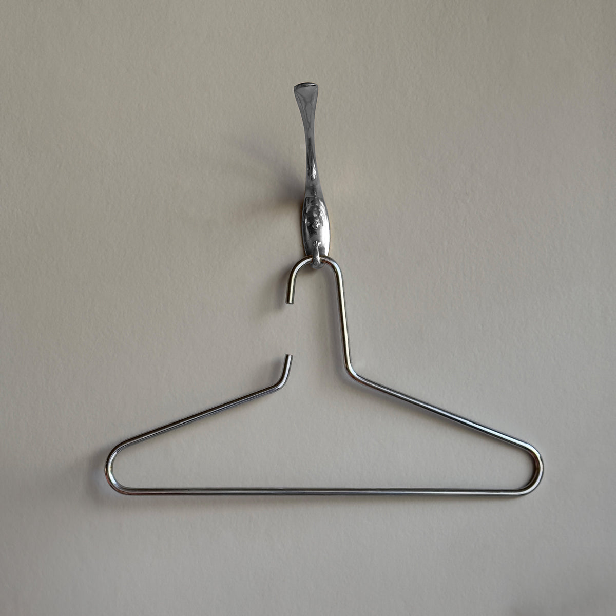 Nickel-plated brass coat hanger by Carl Auböck III, featured in Vienna shop, INDIE, in the 1960s, an architectural project of the 3rd Carl Aubock. This modernist and minimal design exemplifies Auböck’s craftsmanship, blending functionality with sculptural elegance.