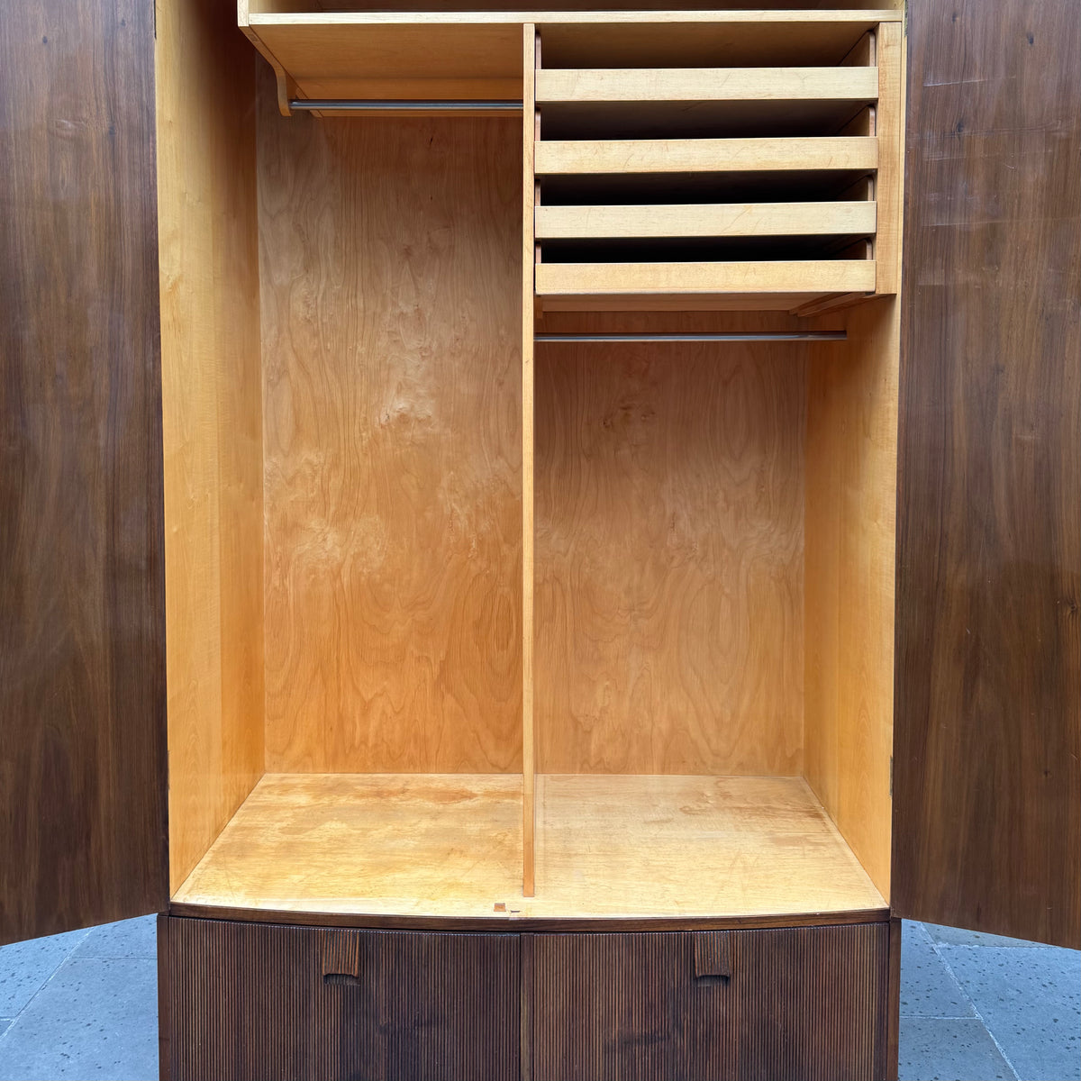 A large mahogany wardrobe designed in Denmark, retailed by Illums Bolighus, and attributed to Kaare Klint. This 1940s piece draws inspiration from Georgian design, showcasing exceptional Danish craftsmanship and timeless elegance.