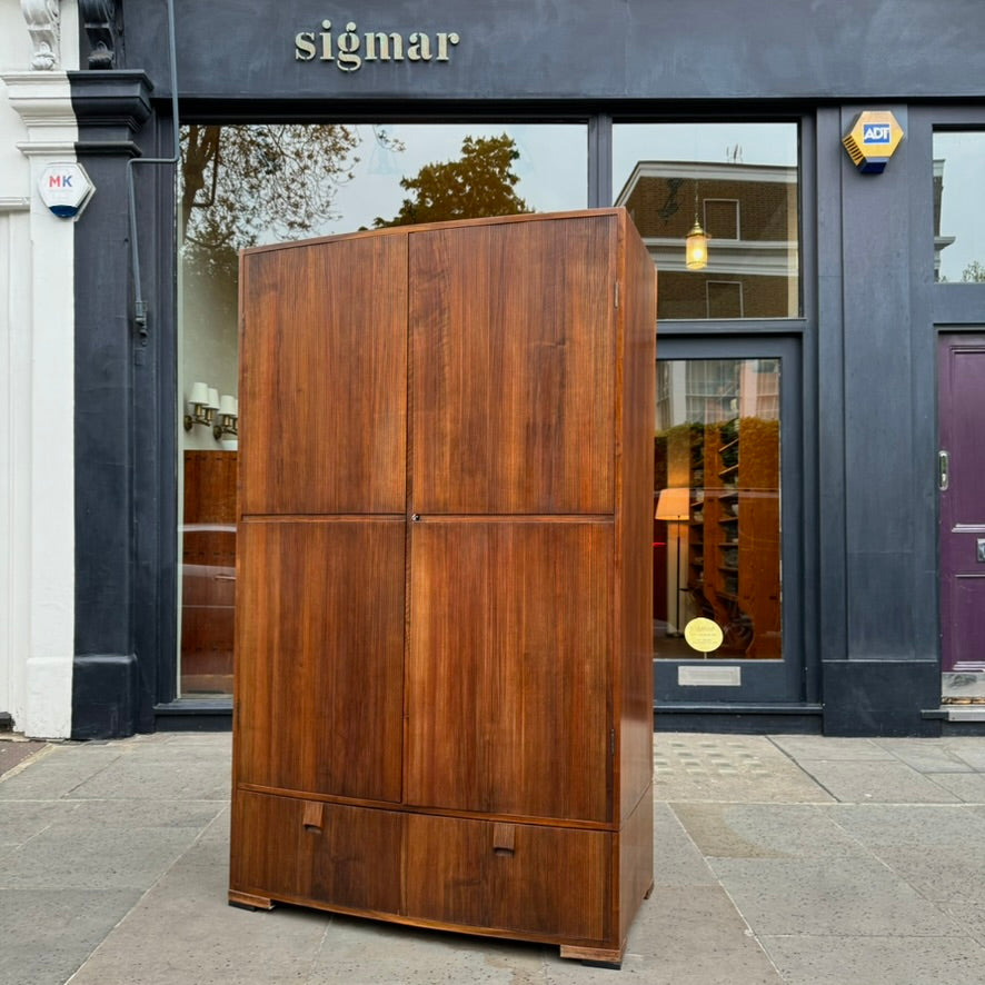 A large mahogany wardrobe designed in Denmark, retailed by Illums Bolighus, and attributed to Kaare Klint. This 1940s piece draws inspiration from Georgian design, showcasing exceptional Danish craftsmanship and timeless elegance.