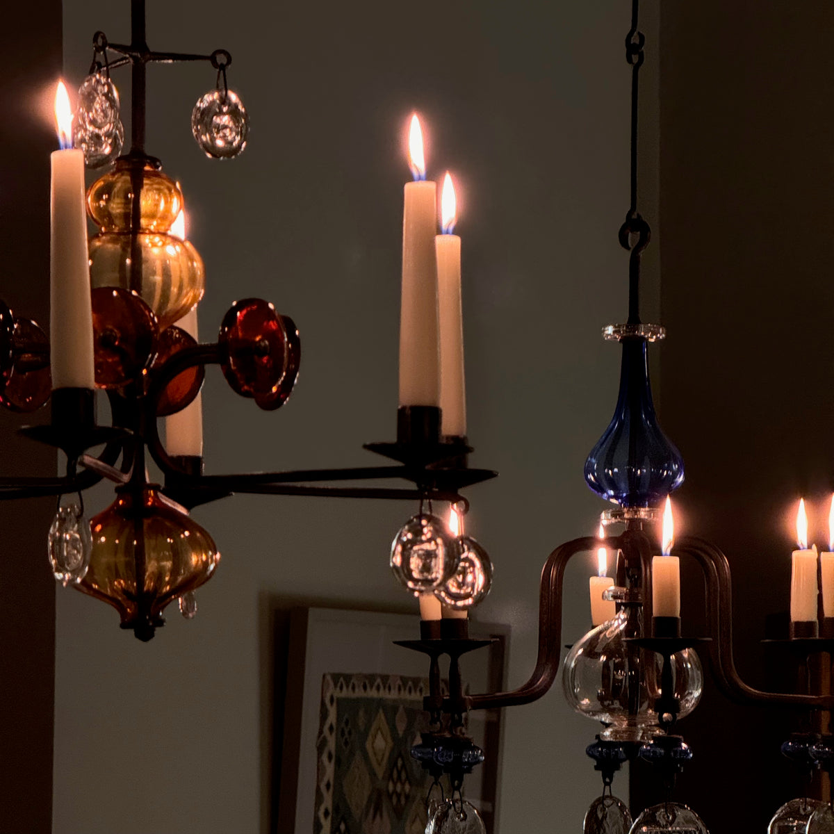 A 1960s amber chandelier by Erik Höglund, featuring pressed glass face details and an iron frame. Crafted for Boda in Sweden, this vintage piece is available from Sigmar and exemplifies mid-century Scandinavian design.