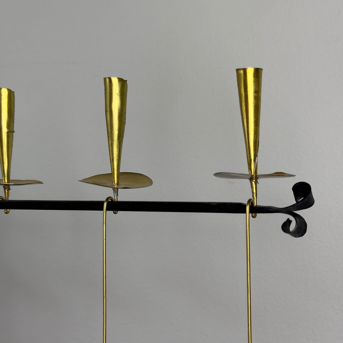 A kinetic candelabrum designed by Thomas Hellström in the 1950s, crafted in Sweden. This unique piece reinterprets Swedish folk aesthetics, blending traditional design elements with a dynamic, mid-century modern twist.