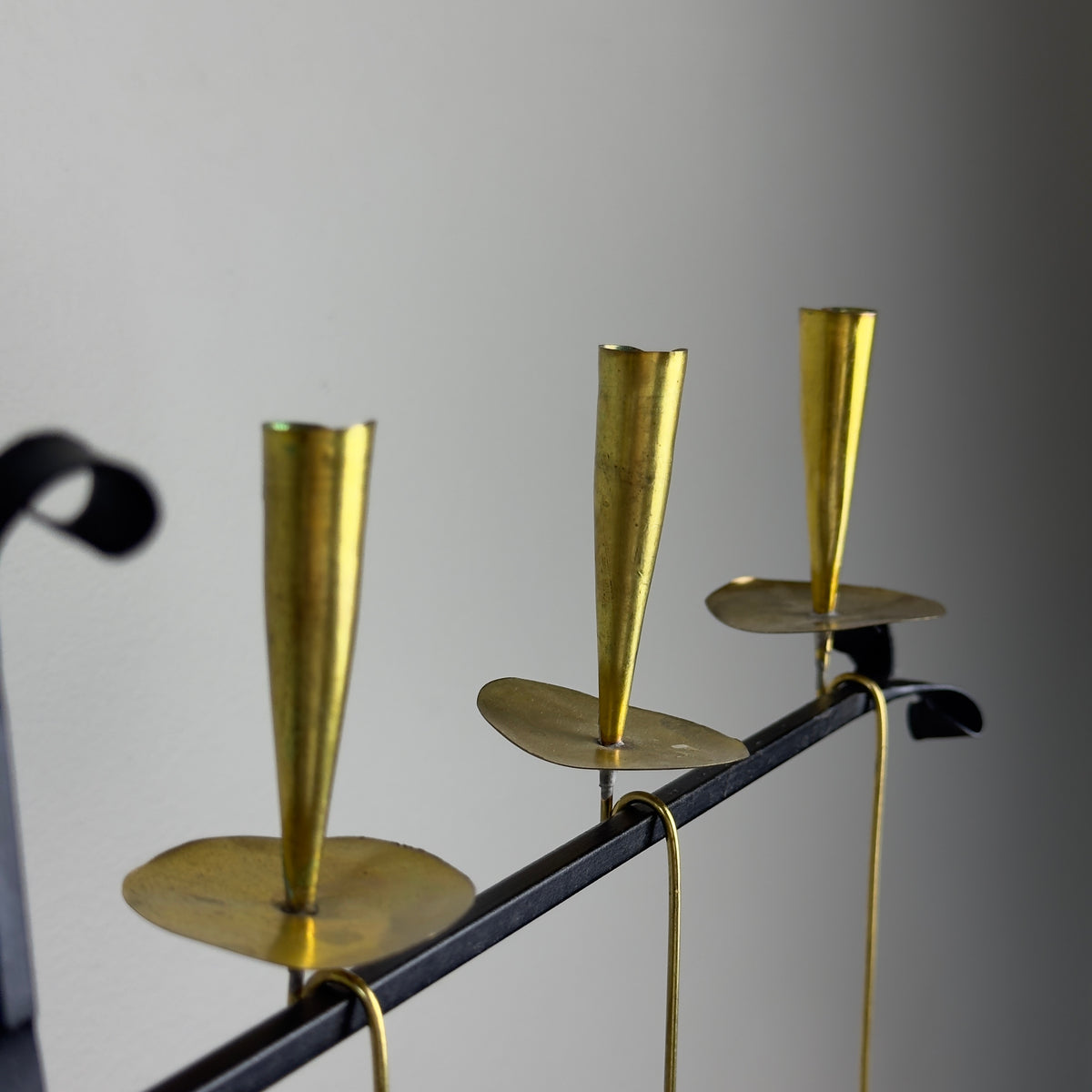 A kinetic candelabrum designed by Thomas Hellström in the 1950s, crafted in Sweden. This unique piece reinterprets Swedish folk aesthetics, blending traditional design elements with a dynamic, mid-century modern twist.