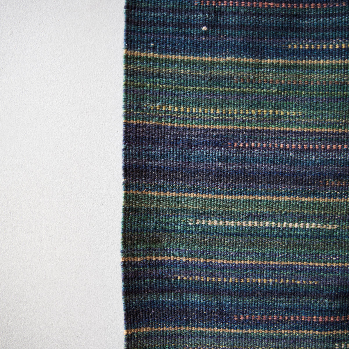 An original large vintage flat-weave rug by Märta Måås-Fjetterström (MMF), crafted in Sweden. Featuring a blue and green palette, this lightweight piece showcases exceptional Swedish textile artistry, available from Sigmar London.