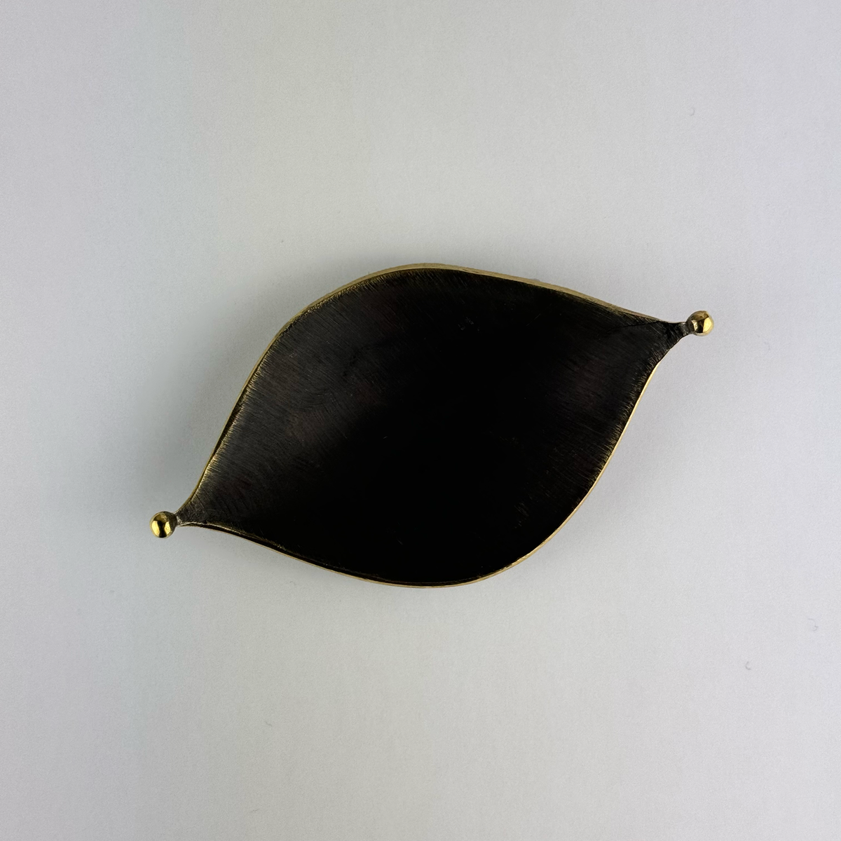 A midcentury leaf tray by Carl Auböck, available at Sigmar London. Crafted in brass with a textured finish, this versatile piece serves as an ashtray or decorative tray, exemplifying modern design and fine Austrian craftsmanship.