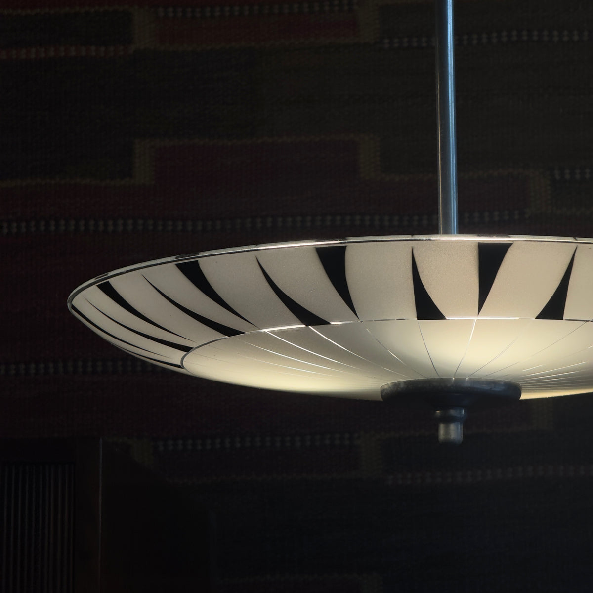 A vintage 1960s umbrella-shaped pendant light by Napako, featuring frosted glass and a geometric design. This piece showcases mid-century modern craftsmanship from Czechoslovakia.