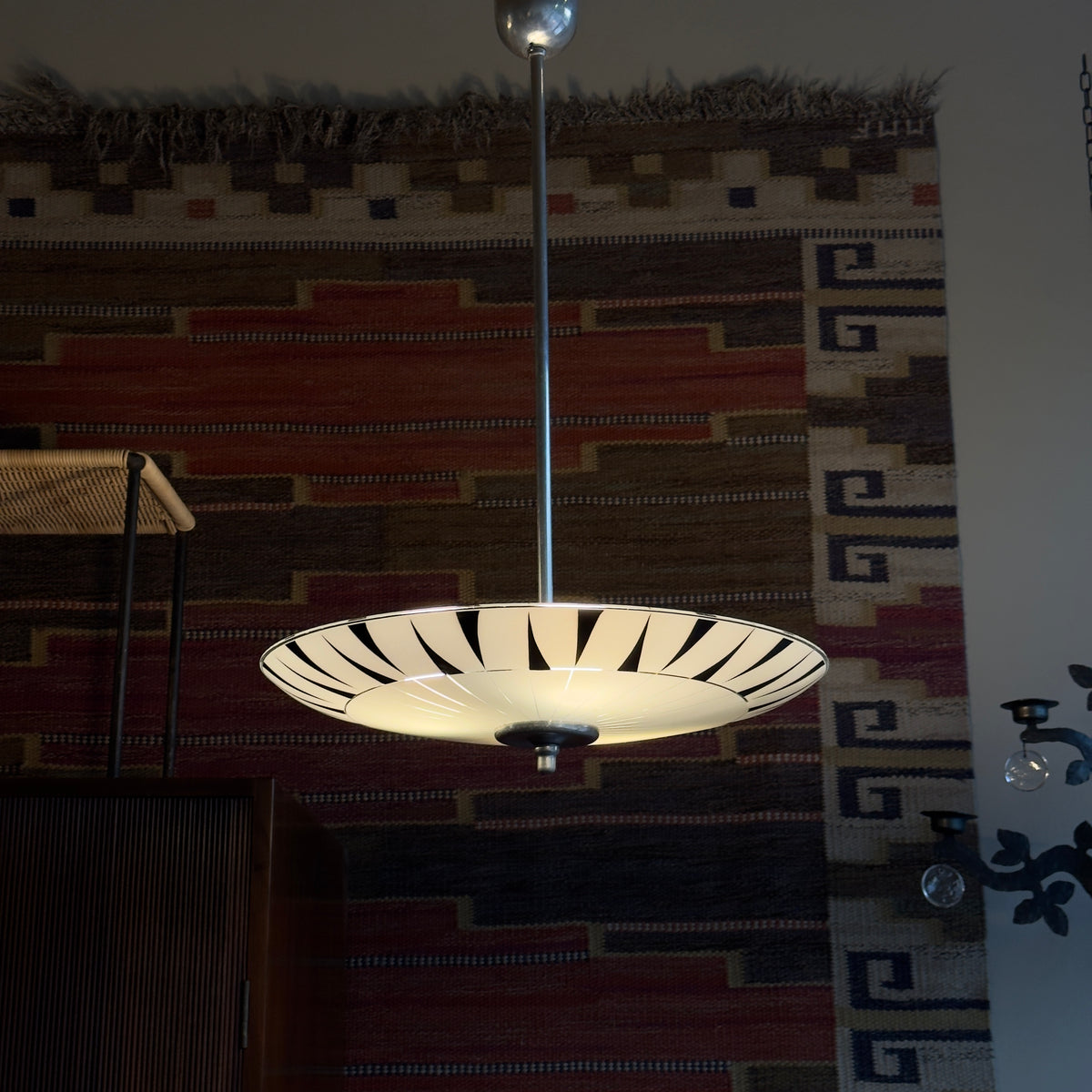 A vintage 1960s umbrella-shaped pendant light by Napako, featuring frosted glass and a geometric design. This piece showcases mid-century modern craftsmanship from Czechoslovakia.