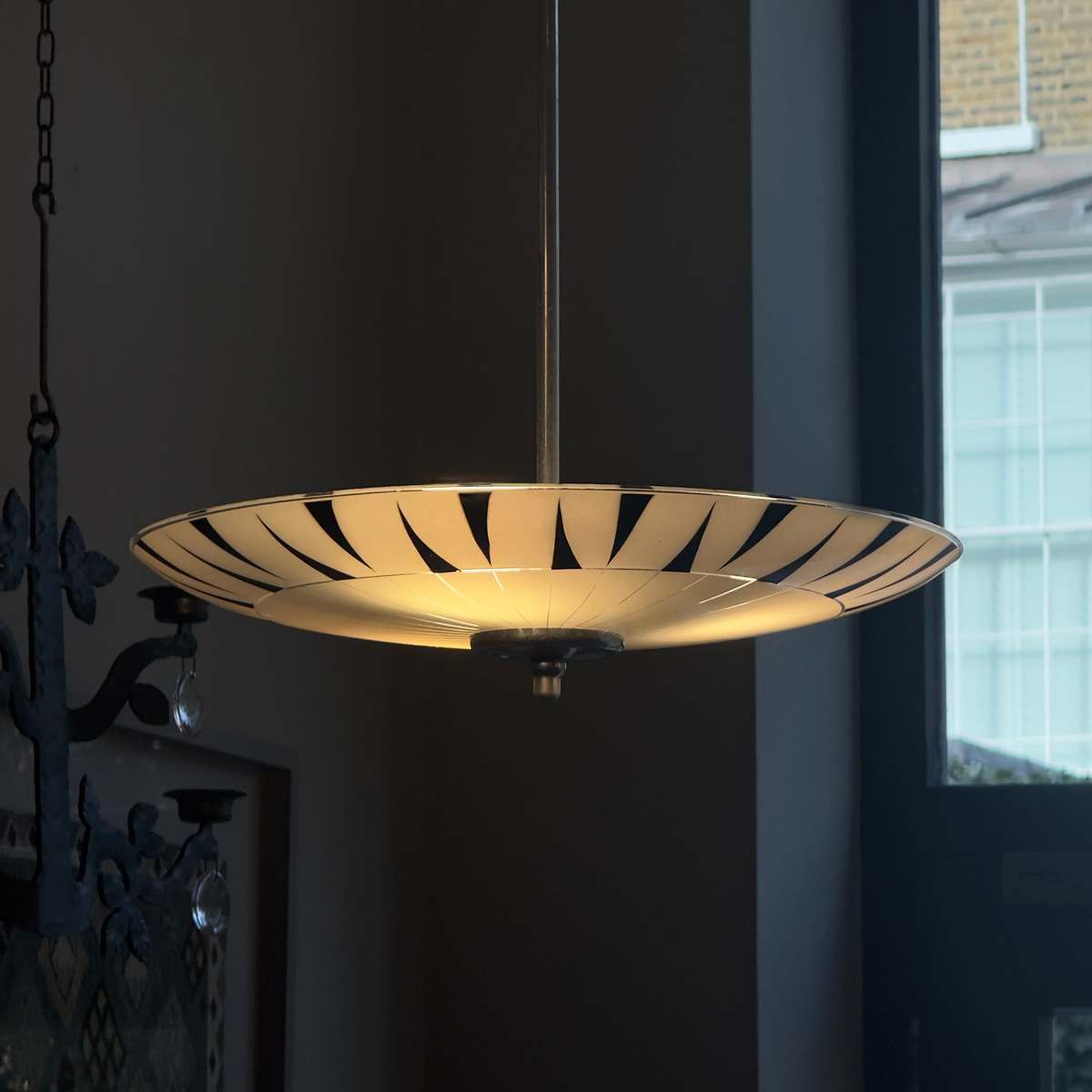 A vintage 1960s umbrella-shaped pendant light by Napako, featuring frosted glass and a geometric design. This piece showcases mid-century modern craftsmanship from Czechoslovakia.