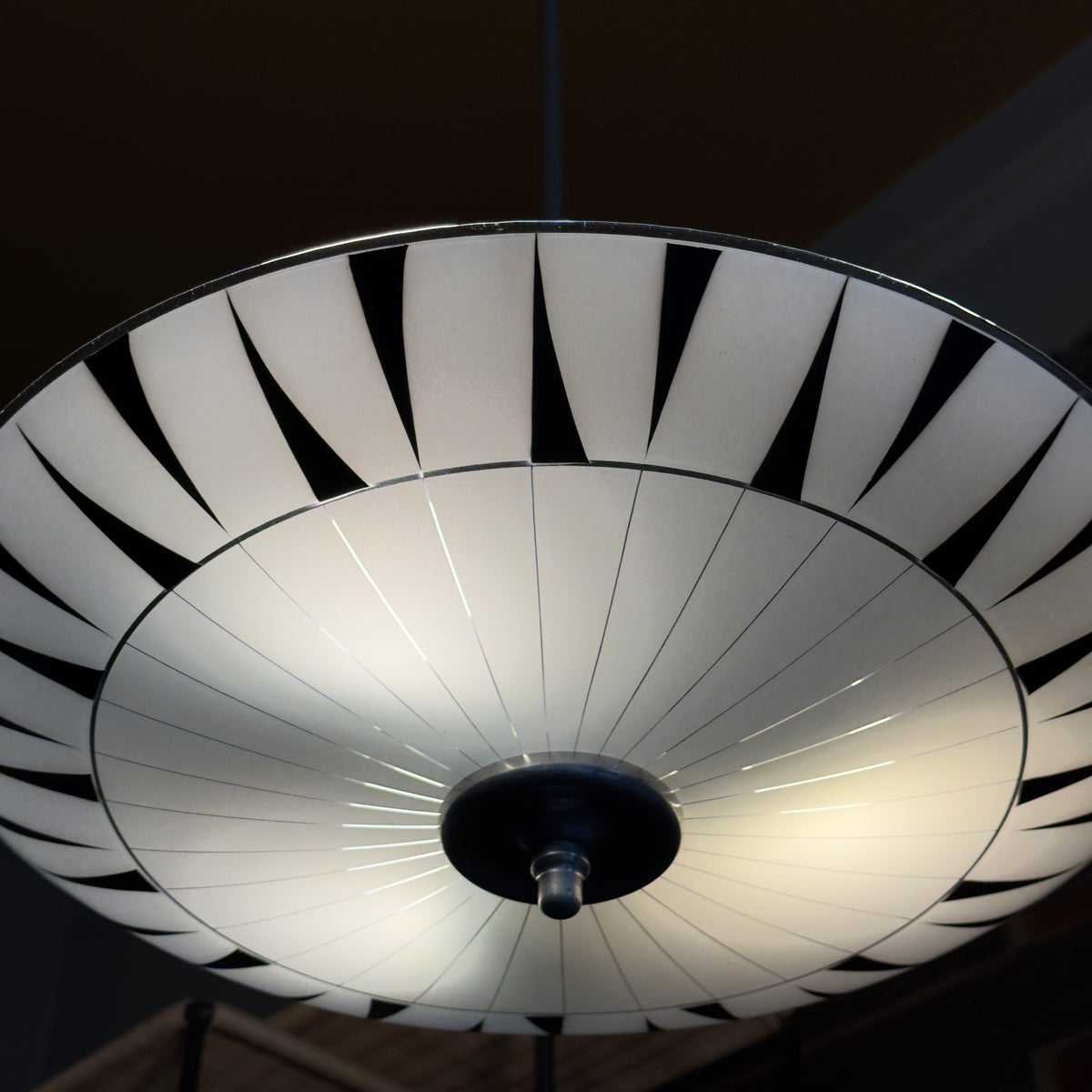 A vintage 1960s umbrella-shaped pendant light by Napako, featuring frosted glass and a geometric design. This piece showcases mid-century modern craftsmanship from Czechoslovakia.