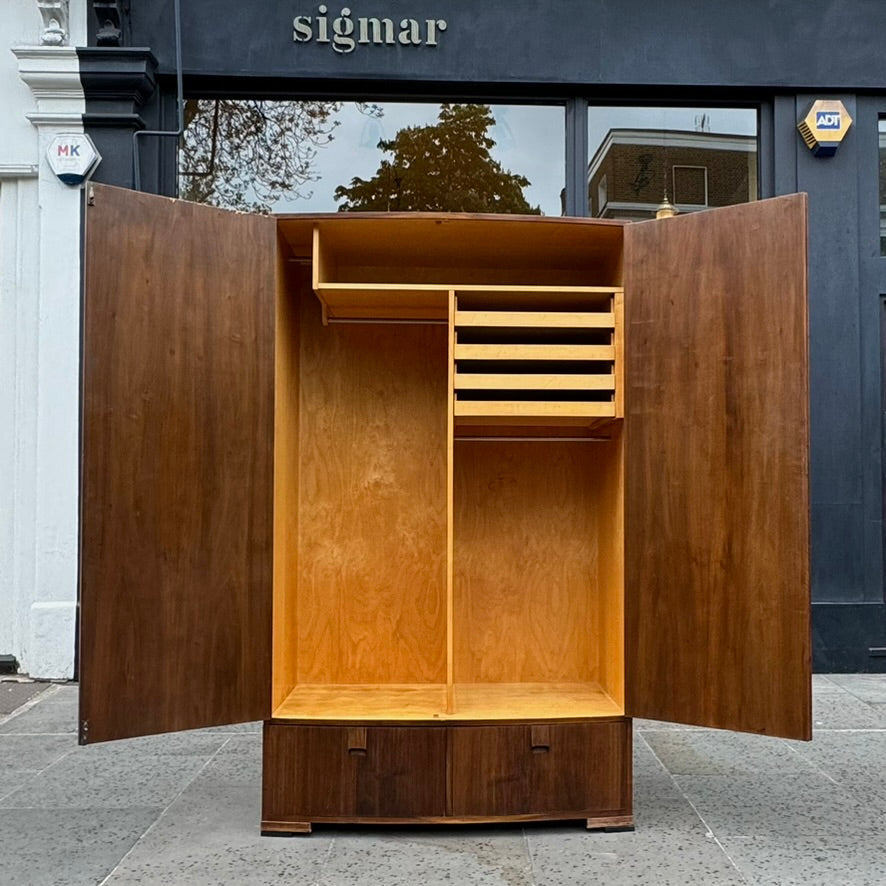 A large mahogany wardrobe designed in Denmark, retailed by Illums Bolighus, and attributed to Kaare Klint. This 1940s piece draws inspiration from Georgian design, showcasing exceptional Danish craftsmanship and timeless elegance.