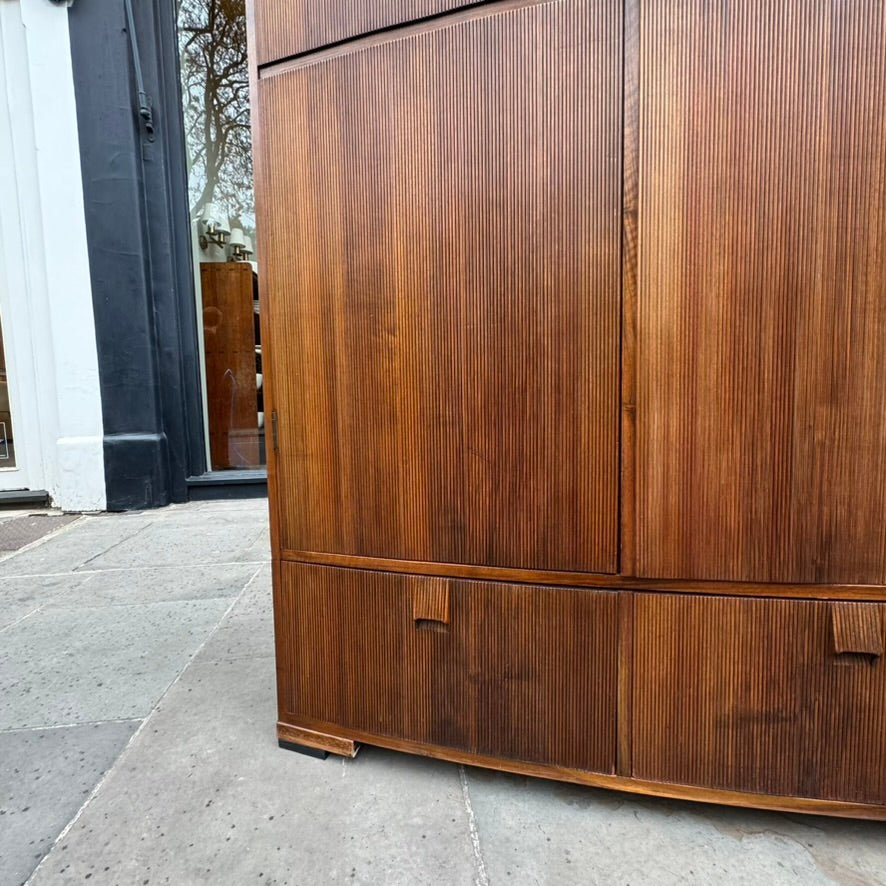 A large mahogany wardrobe designed in Denmark, retailed by Illums Bolighus, and attributed to Kaare Klint. This 1940s piece draws inspiration from Georgian design, showcasing exceptional Danish craftsmanship and timeless elegance.