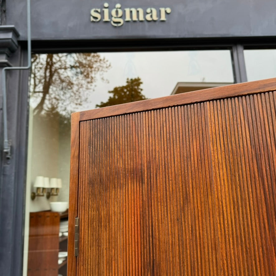 A large mahogany wardrobe designed in Denmark, retailed by Illums Bolighus, and attributed to Kaare Klint. This 1940s piece draws inspiration from Georgian design, showcasing exceptional Danish craftsmanship and timeless elegance.