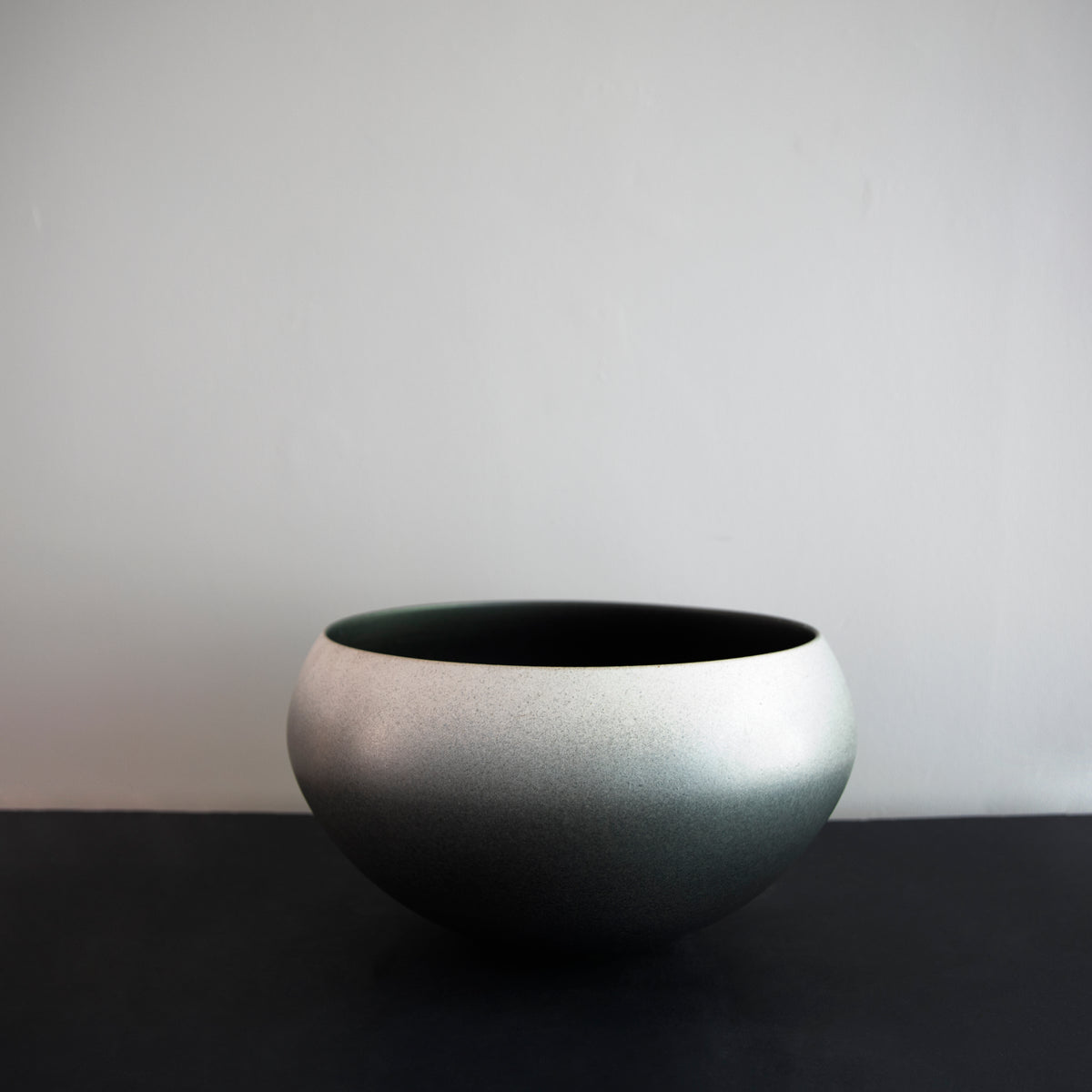 Large onion-shaped vase by Kasper Würtz, featuring a gradient grey glaze. This handcrafted ceramic piece showcases Würtz’s signature Nordic craftsmanship and organic form. Available at Sigmar London.