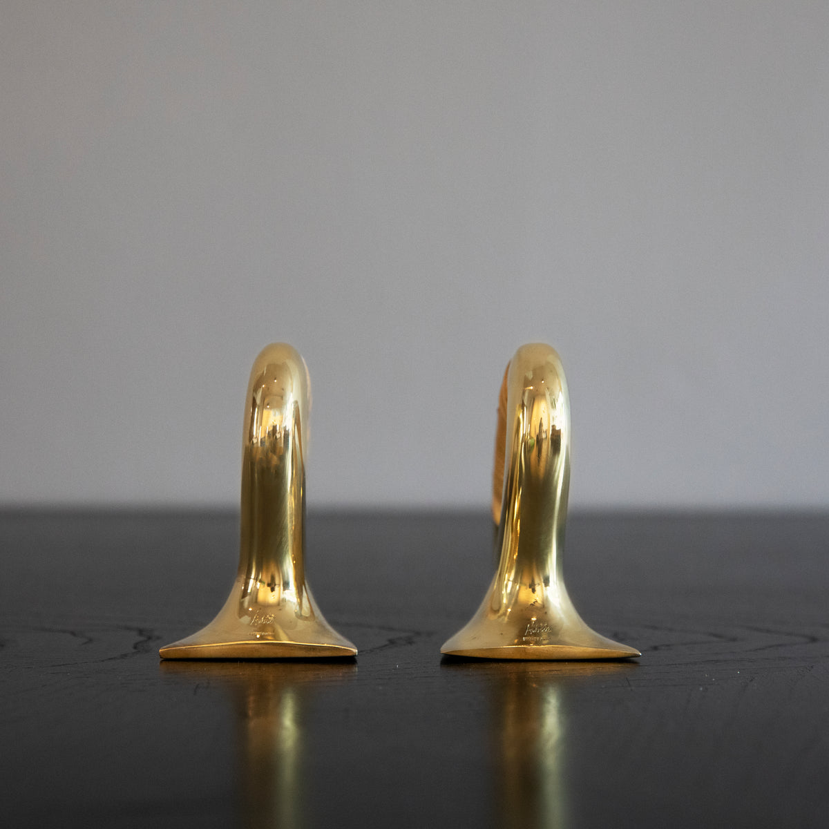 A pair of polished brass flat iron bookends by Carl Auböck, crafted in the Werkstätte Auböck workshop, Austria, 1943. These bookends showcase timeless mid-century Austrian design and exceptional craftsmanship.