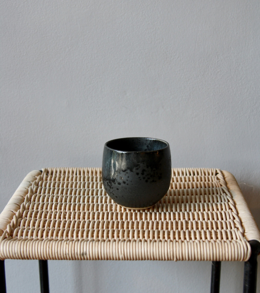 A handcrafted ceramic cup by Kasper Würtz, a Danish ceramicist renowned for his hand-thrown and hand-glazed stoneware. Inspired by Nordic utilitarian crafts and British studio pottery, the design features a balanced inner-outer ratio, subtle concavity, and a glaze that harmoniously blends matte and glossy finishes. Diameter: 7.5 cm, Height: 7.5 cm.